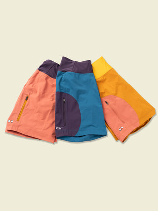 Full collection of Sun Dog shorts in Pink, blue, and buckthron brown