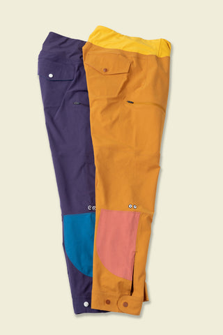 Sun Dog circle color blocks show in blue and pink on the two Pants laid down