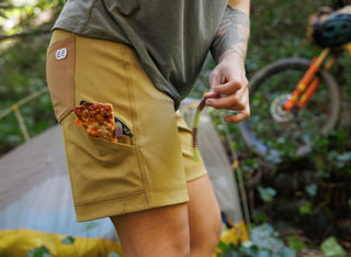 Marley hangs out at camp with gummy worm goodies and leftover pizza tucked into her shorts pocket