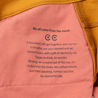 We all came from the muck poem pad printed in black on the inside pocket bag of the ramble scramble shorts on pink soft fabric