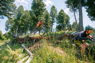 Lila Scot boots off a huge log following Chad Allen down a Bozeman Trail