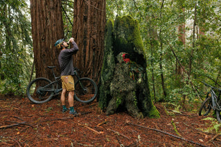 Pasha rests off the trail and grabs a sip of water as his inner creature hides in an old growth stump in Santa Cruz, CA