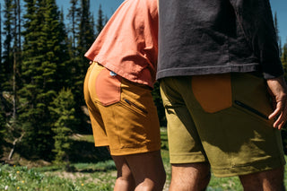 Hillary and Pasha from behind wearing their ramble scramble shorts in buckthorn brown and avocado green